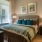 Spacious and well lit bedroom with plush carpet and large windows
